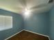 This bedroom features a ceiling fan, wood-look floors and a large window providing natural light at 6618 Kenwood Dr, North Port, FL 34287