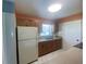 Bright kitchen features wood cabinets and tile flooring at 6618 Kenwood Dr, North Port, FL 34287