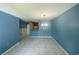 Open-concept living area with tile flooring, blue walls and dining chandelier at 6618 Kenwood Dr, North Port, FL 34287