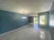 Living room with tile flooring, chandelier, and natural light from a sliding door at 6618 Kenwood Dr, North Port, FL 34287