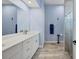 Bright bathroom with double vanity, marble countertop, and a tiled glass shower at 6636 35Th E Ct, Sarasota, FL 34243