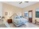 Comfortable bedroom with beautiful hardwood floors and a metal frame bed at 6636 35Th E Ct, Sarasota, FL 34243