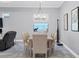 Bright dining room featuring a modern chandelier, large window, and neutral tones at 6636 35Th E Ct, Sarasota, FL 34243
