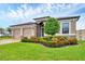 Well-manicured front yard and two car garage, complementing this home's exterior and beautiful garden at 6636 35Th E Ct, Sarasota, FL 34243