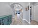 Elegant hallway with tile flooring, arched ceilings, and stylish turquoise cabinet at 6636 35Th E Ct, Sarasota, FL 34243