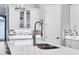Well-appointed kitchen featuring white cabinets, a center island, and a stylish faucet, ready for culinary adventures at 6636 35Th E Ct, Sarasota, FL 34243