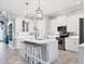 Contemporary kitchen featuring white cabinets, an island with bar stools, and modern stainless steel appliances at 6636 35Th E Ct, Sarasota, FL 34243