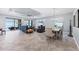 Open living and dining area with tile floors, tray ceilings, and sliding glass doors at 6636 35Th E Ct, Sarasota, FL 34243