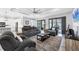 Bright living room with an open floor plan featuring a ceiling fan and seamless access to outdoor entertainment at 6636 35Th E Ct, Sarasota, FL 34243