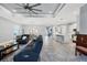 Spacious living room with a large sectional, tile flooring, a ceiling fan, and recessed lighting throughout at 6636 35Th E Ct, Sarasota, FL 34243