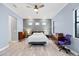 Spacious main bedroom with light wood floors, modern ceiling fan, and ample natural light at 6636 35Th E Ct, Sarasota, FL 34243