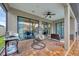 Outdoor patio featuring a hanging chair, ceiling fan, and seating area, perfect for relaxation at 6636 35Th E Ct, Sarasota, FL 34243