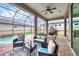 Outdoor patio with comfortable seating, string lights, and a view of the sparkling pool at 6636 35Th E Ct, Sarasota, FL 34243