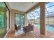 Screened patio offering cozy seating and serene views of the pool and backyard at 6636 35Th E Ct, Sarasota, FL 34243