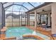 Backyard pool and patio area featuring a hot tub, water feature and seating area at 6636 35Th E Ct, Sarasota, FL 34243