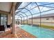 Screened-in pool featuring fountains, a spa, and patio furniture, ideal for outdoor enjoyment at 6636 35Th E Ct, Sarasota, FL 34243