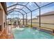 Enclosed swimming pool with water features, string lights, and outdoor lounge area at 6636 35Th E Ct, Sarasota, FL 34243
