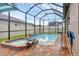 Spa and pool area with water fountains and a screened enclosure with string lights at 6636 35Th E Ct, Sarasota, FL 34243
