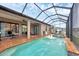 Relaxing screened-in pool with a covered patio, fountains, and outdoor seating at 6636 35Th E Ct, Sarasota, FL 34243