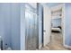 Bathroom shower with glass door, and open access to the bedroom area at 6636 35Th E Ct, Sarasota, FL 34243