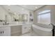 Spacious bathroom boasting double sinks, soaking tub, a large mirror and stylish modern finishes at 6641 Saint James Xing, University Park, FL 34201