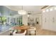 Light-filled breakfast nook featuring wood table, white chairs, and views of the lanai at 6641 Saint James Xing, University Park, FL 34201