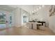 Bright dining room with a modern chandelier, large windows, and hardwood flooring at 6641 Saint James Xing, University Park, FL 34201
