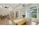 Elegant dining room with a modern chandelier, large windows, and access to the living spaces at 6641 Saint James Xing, University Park, FL 34201