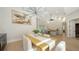 Spacious dining area with modern lighting and neutral decor, open to the living room at 6641 Saint James Xing, University Park, FL 34201