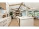 Open kitchen with large island, stainless appliances, and a view into the modern Gathering room at 6641 Saint James Xing, University Park, FL 34201