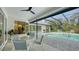 Covered lanai featuring a seating area and a view of the sparkling pool at 6641 Saint James Xing, University Park, FL 34201