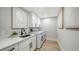 Functional laundry room with modern appliances, ample storage, and a sleek design at 6641 Saint James Xing, University Park, FL 34201