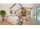 Inviting living room with vaulted ceilings, decorative beams, and a modern fireplace feature at 6641 Saint James Xing, University Park, FL 34201