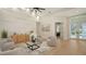 Inviting living room featuring modern furniture, wood floors, and a decorative accent wall at 6641 Saint James Xing, University Park, FL 34201
