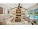Bright and airy living room with a modern fireplace and sliding doors to the pool area at 6641 Saint James Xing, University Park, FL 34201