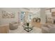 Bright and airy living room with high ceilings, neutral decor, and views of the outdoors at 6641 Saint James Xing, University Park, FL 34201
