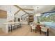 Open-concept living space with a kitchen island, dining area, and Gathering room with a fireplace at 6641 Saint James Xing, University Park, FL 34201