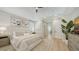 Bright main bedroom with neutral tones, walk-in closet, and ensuite bathroom featuring dual vanities at 6641 Saint James Xing, University Park, FL 34201