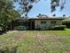 View of back of house with screen enclosed pool and spa at 6839 Turnberry Isle Ct, Lakewood Ranch, FL 34202