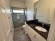 Modern bathroom with granite countertop vanity and sleek walk-in shower with natural light at 6839 Turnberry Isle Ct, Lakewood Ranch, FL 34202