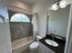Cozy bathroom featuring a combination tub and shower with a window at 6839 Turnberry Isle Ct, Lakewood Ranch, FL 34202