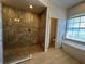 Luxurious bathroom with a glass-enclosed shower, freestanding tub, and tile floors for a spa-like experience at 6839 Turnberry Isle Ct, Lakewood Ranch, FL 34202