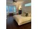 Comfortable bedroom featuring a bay window, hardwood floors, and neutral decor creating a relaxing atmosphere at 6839 Turnberry Isle Ct, Lakewood Ranch, FL 34202
