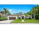 Charming home featuring mature landscaping, a well-manicured lawn, and a welcoming entrance at 6839 Turnberry Isle Ct, Lakewood Ranch, FL 34202
