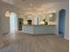 Open-concept kitchen with stainless steel appliances, white cabinets, and modern lighting fixtures at 6839 Turnberry Isle Ct, Lakewood Ranch, FL 34202