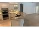 Modern kitchen with granite countertops, stainless appliances, tile backsplash, and sleek wood flooring at 6839 Turnberry Isle Ct, Lakewood Ranch, FL 34202