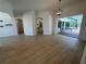 Bright and airy living room featuring tile floors, an open layout, and access to the outdoor screened pool area at 6839 Turnberry Isle Ct, Lakewood Ranch, FL 34202