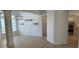 Inviting living room boasting tile floors, bright lighting, and adjacent kitchen, creating an open concept space at 6839 Turnberry Isle Ct, Lakewood Ranch, FL 34202