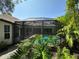 Secluded screened-in pool area surrounded by tropical landscaping at 6839 Turnberry Isle Ct, Lakewood Ranch, FL 34202
