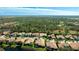 Gorgeous aerial view features the residences, ponds, and expansive greenery of the neighborhood at 7081 Grassland Ct, Sarasota, FL 34241